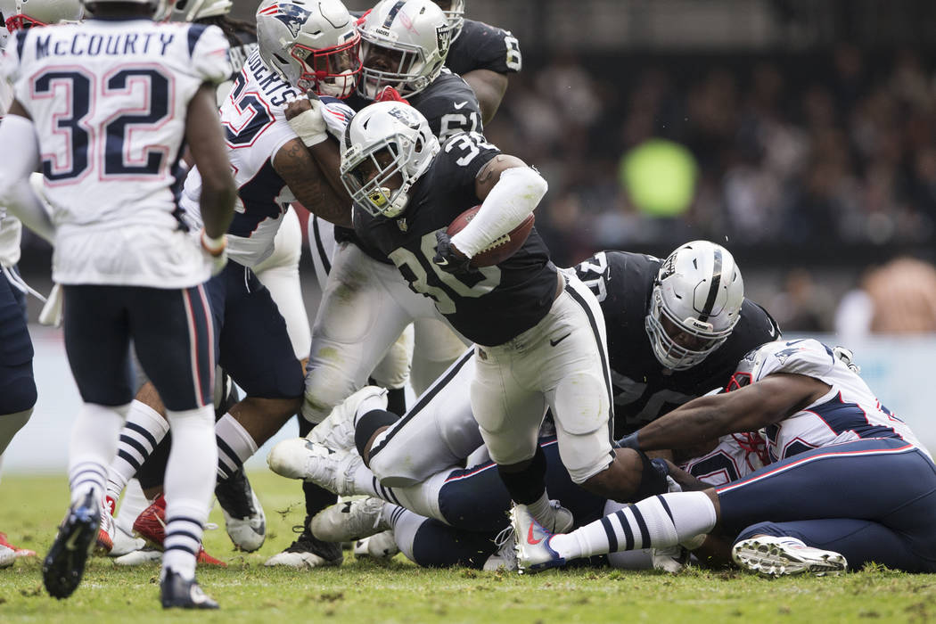 Oakland Raiders running back Jalen Richard (30) runs the ball against the New England Patriots in the NFL football game at Estadio Azteca in Mexico City, Sunday, Nov. 19, 2017. Erik Verduzco Las V ...