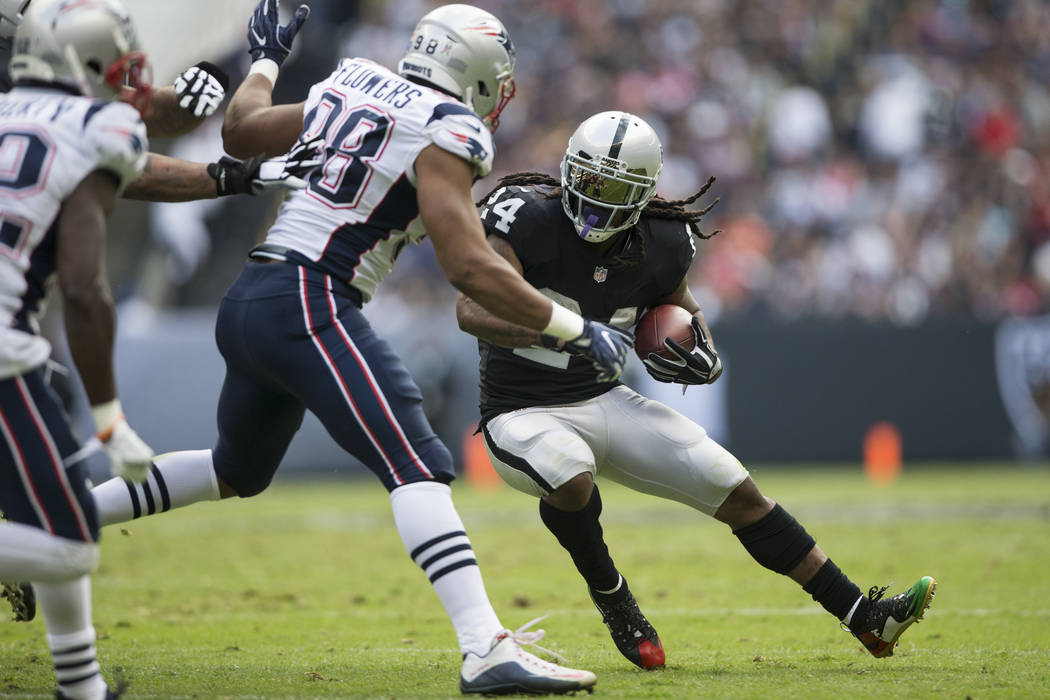Oakland Raiders running back Marshawn Lynch (24) runs the ball against the New England Patriots in the NFL football game at Estadio Azteca in Mexico City, Sunday, Nov. 19, 2017. Erik Verduzco Las ...