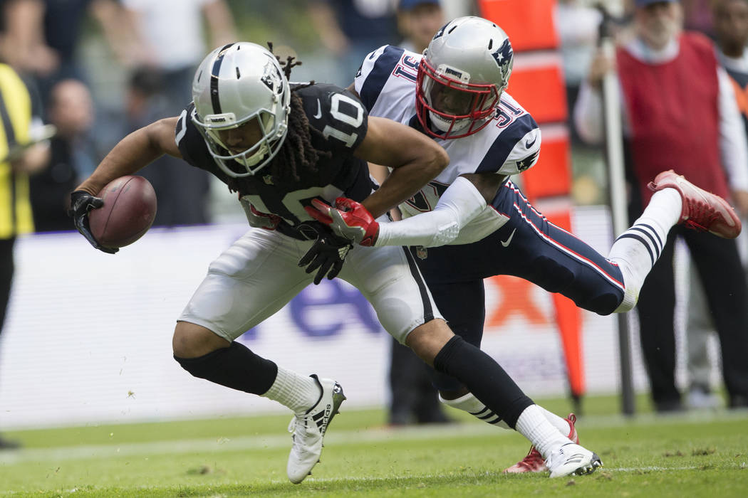 Oakland Raiders wide receiver Seth Roberts (10) before fumbling the ball against New England Patriots cornerback Jonathan Jones (31) in the NFL football game at Estadio Azteca in Mexico City, Sund ...