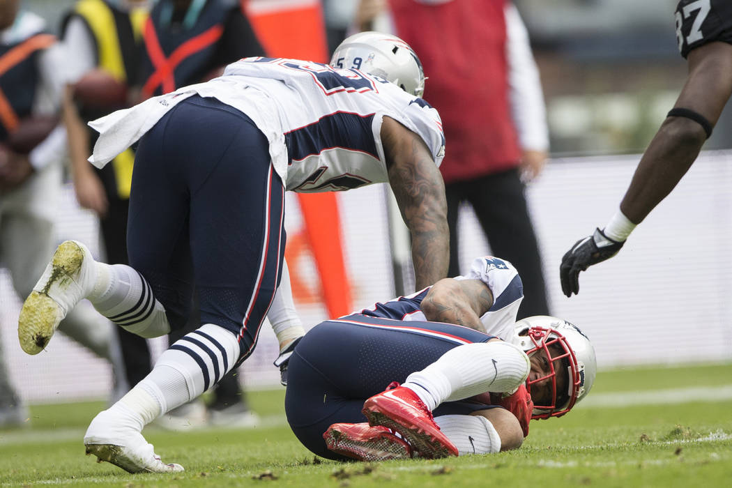 New England Patriots strong safety Patrick Chung (23) recovers a fumble the the Oakland Raiders in the NFL football game at Estadio Azteca in Mexico City, Sunday, Nov. 19, 2017. Erik Verduzco Las  ...