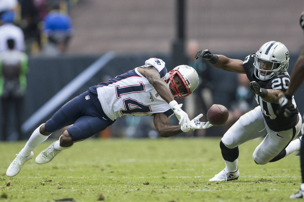 New England Patriots wide receiver Brandin Cooks (14) missed a catch against Oakland Raiders safety Obi Melifonwu (20) in the NFL football game at Estadio Azteca in Mexico City, Sunday, Nov. 19, 2 ...