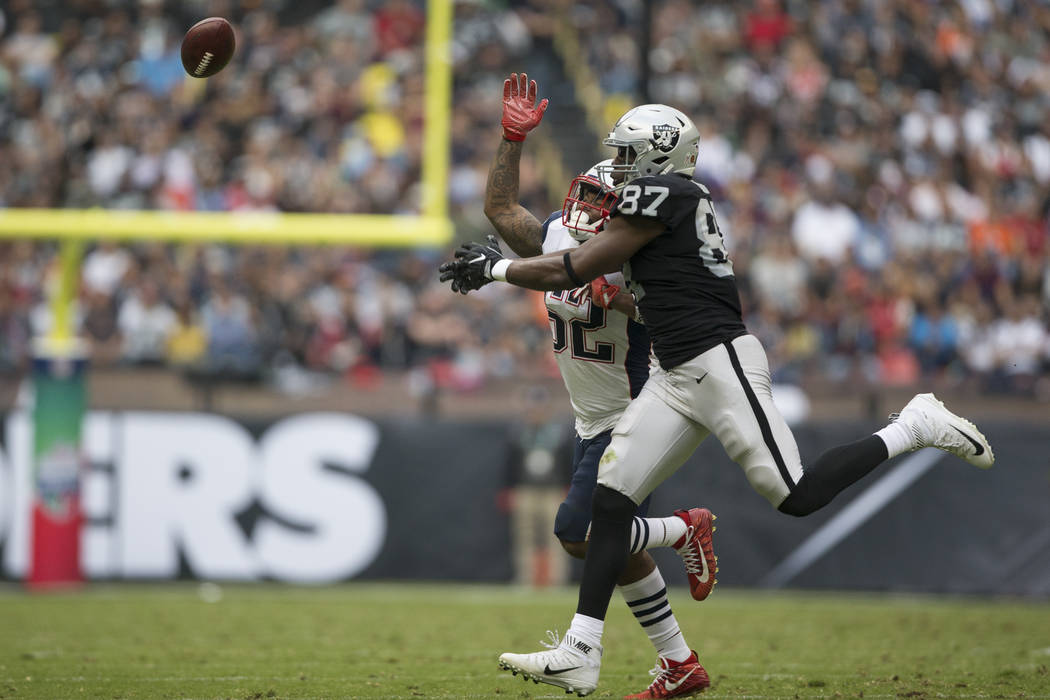 Oakland Raiders tight end Jared Cook (87) watches the ball for an incomplete pass against New England Patriots outside linebacker Elandon Roberts (52) in the NFL football game at Estadio Azteca in ...