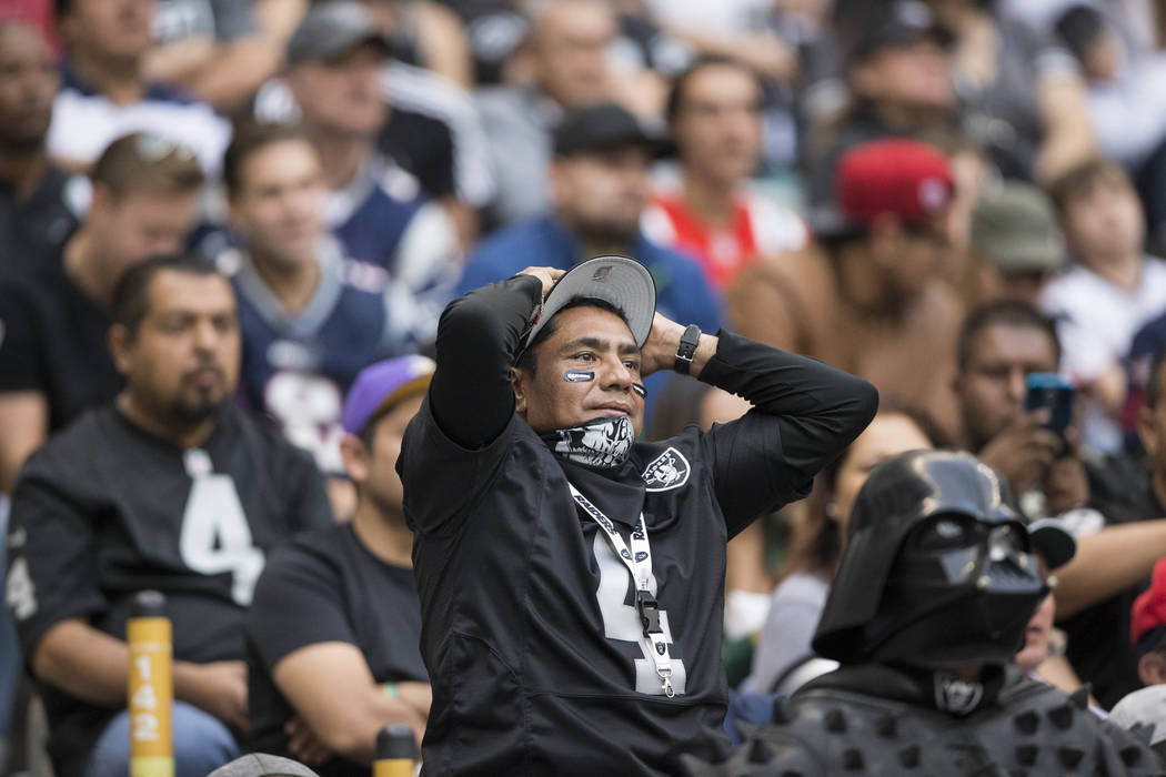 A fan reacts to a play in the NFL football game between the Oakland Raiders and New England Patriots at Estadio Azteca in Mexico City, Sunday, Nov. 19, 2017. New England Patriots won 33-8. Erik Ve ...