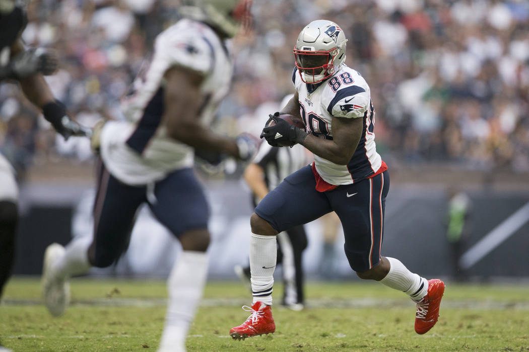 New England Patriots tight end Martellus Bennett (88) runs the ball against the Oakland Raiders in the NFL football game at Estadio Azteca in Mexico City, Sunday, Nov. 19, 2017. New England Patrio ...
