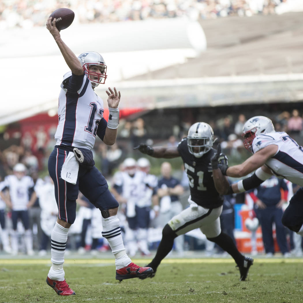 New England Patriots quarterback Tom Brady (12) throws the ball for a touchdown against the Oakland Raiders in the NFL game at Estadio Azteca in Mexico City, Sunday, Nov. 19, 2017. Erik Verduzco L ...