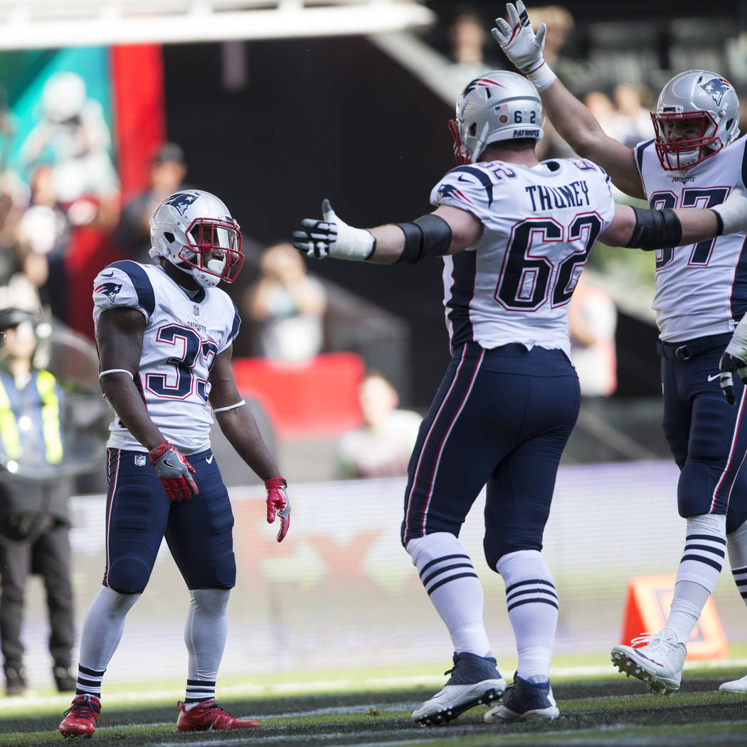 New England Patriots running back Dion Lewis (33) celebrates his touchdown against the Oakland Raiders at Estadio Azteca in Mexico City, Sunday, Nov. 19, 2017. New England Patriots won 33-8. Erik ...