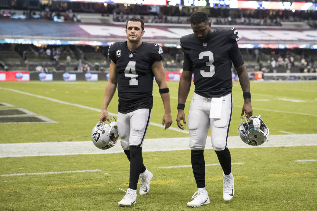 Oakland Raiders quarterback Derek Carr (4) and Oakland Raiders quarterback EJ Manuel (3) walk off the field at Estadio Azteca after their game against the New England Patriots in Mexico City, Sund ...