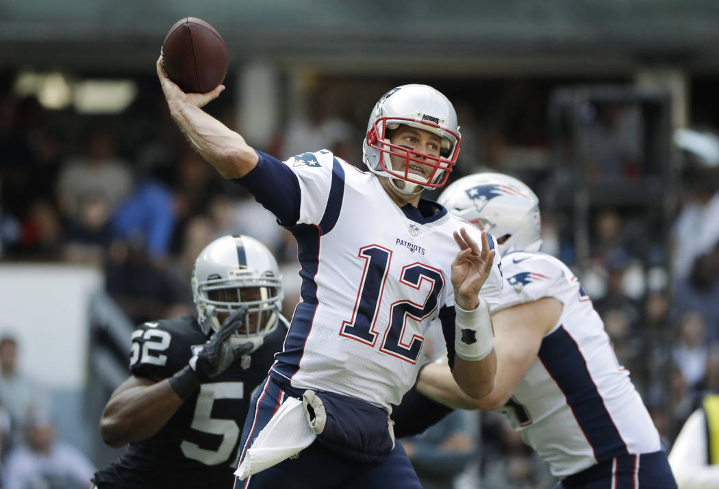 New England Patriots quarterback Tom Brady (12) passes against the Oakland Raiders during the first half of an NFL football game Sunday, Nov. 19, 2017, in Mexico City. (AP Photo/Rebecca Blackwell)