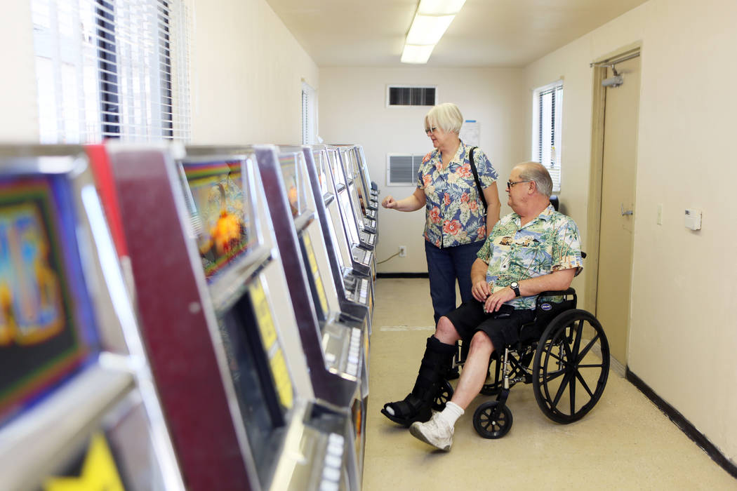 Barbara Moore and her husband Ron play a slot machine inside a modular building at Moulin Rouge, located at 900 West Bonanza Rd., Wednesday, June 11, 2014, in Las Vegas. Gaming was available tempo ...