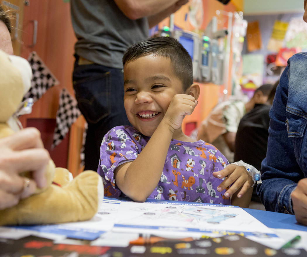 Geovany Sanches, 4, giggles at a bear given to him during NASCAR champion Martin Truex, Jr.'s visit at Sunrise Children's Hospital in Las Vegas, Tuesday, Nov. 28, 2017. Elizabeth Brumley Las Vegas ...