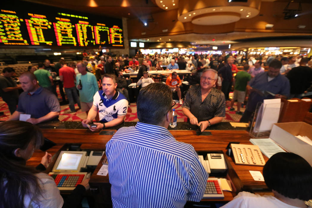 Bookmaker Jay Rood at the Race & Sports Book betting counter at the Mirage casino where crowds place bets for Super Bowl Sunday. Rachel Aston/Las Vegas Review-Journal Follow @rookie__rae