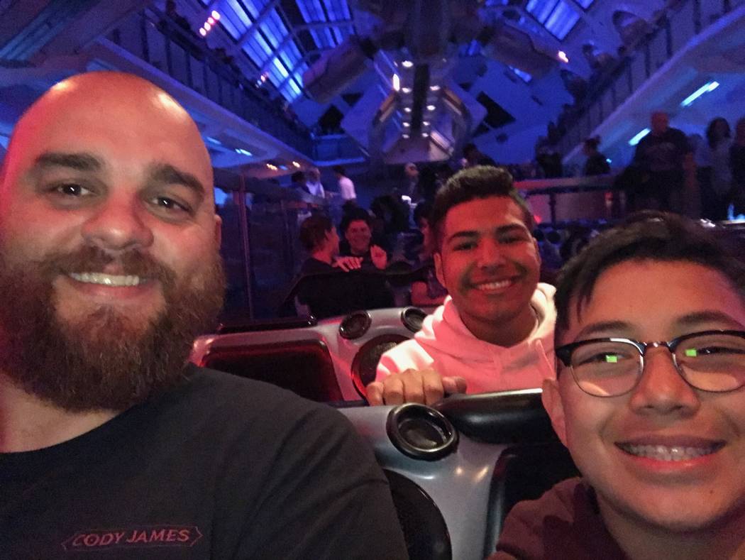 Chris Jaksha rides a roller coaster at Disneyland with Marcus Guillen, 18, center, and his brother Chris, 13, in November in Anaheim, Calif. (Jaksha family)