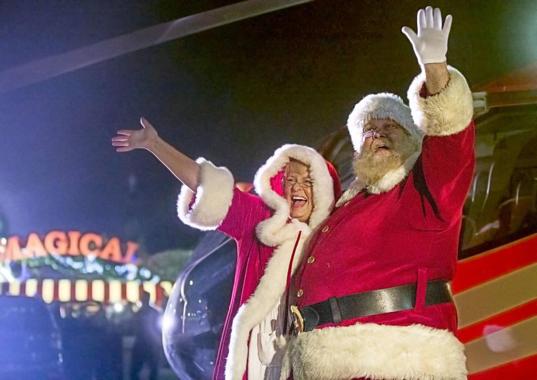 Santa and Mrs. Claus wave to attendees from their Papillon Grand Canyon Helicopter after landing at Opportunity Village's Magical Forest on Friday, Nov. 24, 2017, in Las Vegas. Benjamin Hager Las  ...