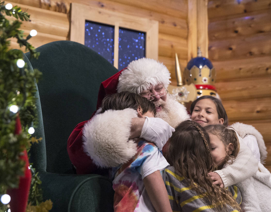 Santa hugs a group of children at Opportunity Village's Magical Forest on Friday, Nov. 24, 2017, in Las Vegas. Benjamin Hager Las Vegas Review-Journal @benjaminhphoto