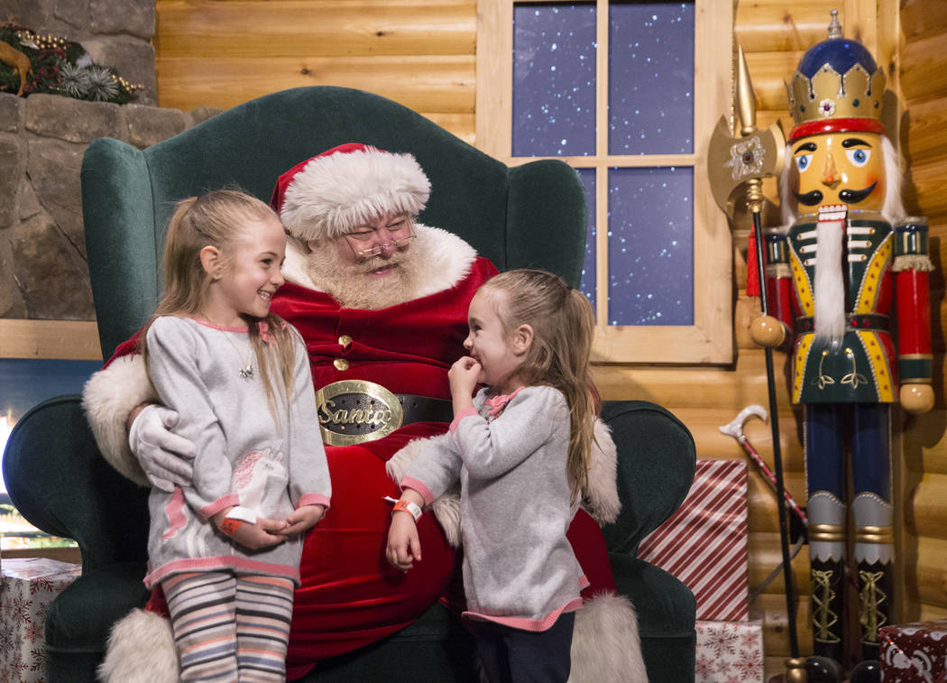 Santa listens to toy requests from Selena Dexter, left, and sister Sophie at Opportunity Village's Magical Forest on Friday, Nov. 24, 2017, in Las Vegas. Benjamin Hager Las Vegas Review-Journal @b ...