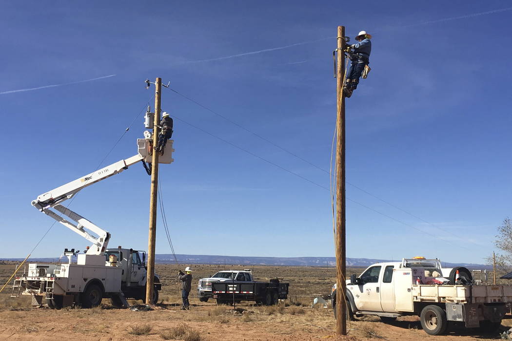 Workers run electricity to Annie Hamm's home on the Navajo Nation near Montezuma Creek, Utah. (Deenise Becenti/Navajo Tribal Utility Authority via AP)