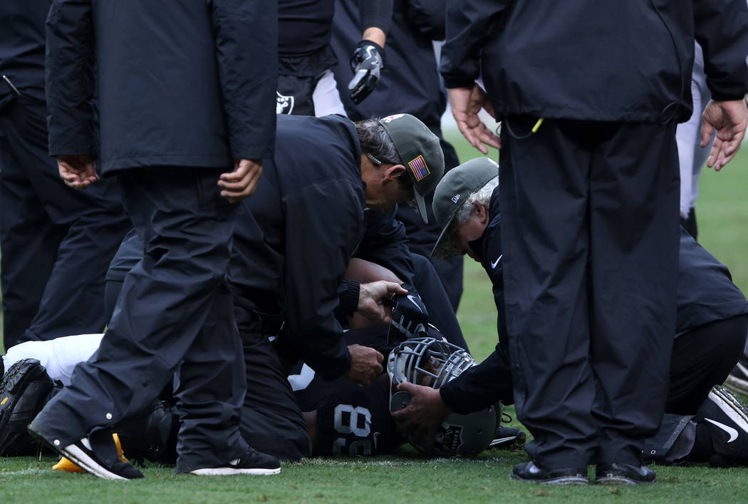 Oakland Raiders wide receiver Amari Cooper (89) lays on the field unconscious as trainers tend to him during the first half of a NFL game  against the Denver Broncos in Oakland, Calif., Sunday, No ...
