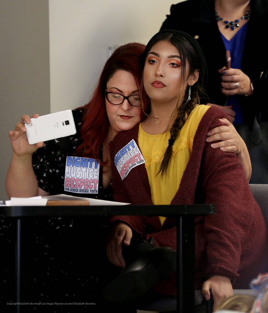 Family services coordinator for Gender Justice Nevada Laura Hernandez, left, hugs her transgender child Kristina Hernandez after they spoke during a meeting regarding transgender policies for the  ...