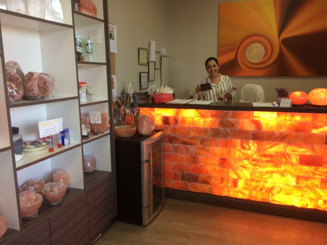 Ava Mucikyan, conducts business behind a Himalayan salt rock counter Nov. 1, 2017, while talking about her business, Salt Room LV, in Trails Village. The business' biggest draw is the salt cave, w ...