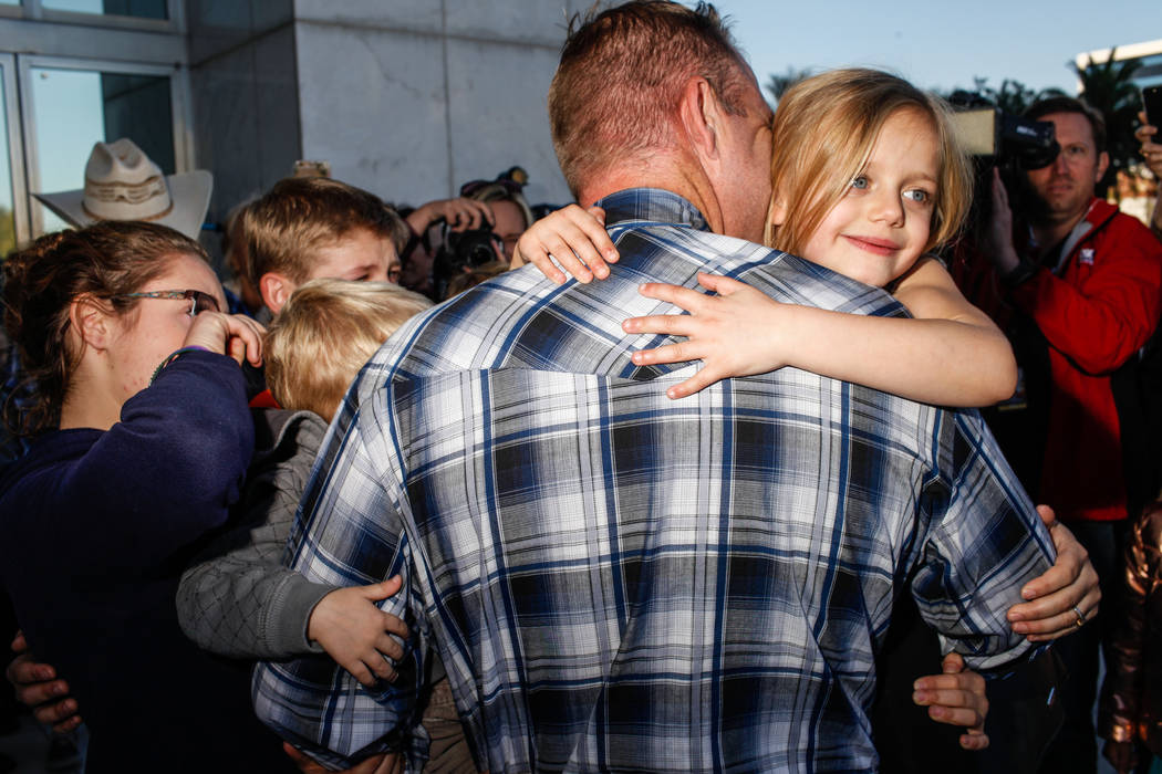 Ammon Bundy embraces his children outside the Lloyd George U.S. Courthouse in Las Vegas after being released from custody Thursday, Nov. 30, 2017. Bundy's trial related to a 2014 Bunkerville stand ...