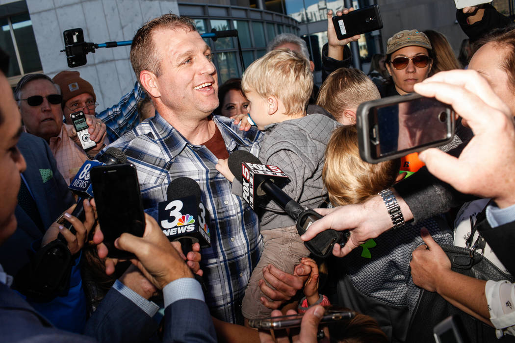 Ammon Bundy embraces his children outside the Lloyd George U.S. Courthouse in Las Vegas after being released from custody Thursday, Nov. 30, 2017. Bundy's trial related to a 2014 Bunkerville stand ...