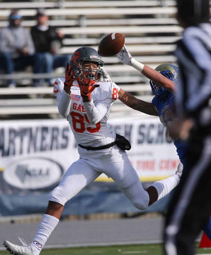 Bishop Gorman’s Rome Odunze tries to make a catch under pressure from Reed’s George Moreno during the first half of the NIAA 4A state championship football game in Reno, Nev., on Sat ...