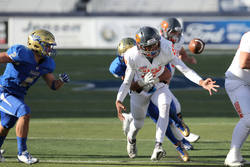 An unidentified Reed defender knocks the ball loose from the hands of Bishop Gorman’s Issac Alcaraz in the second half of the NIAA 4A state championship football game in Reno, Nev., on Satu ...