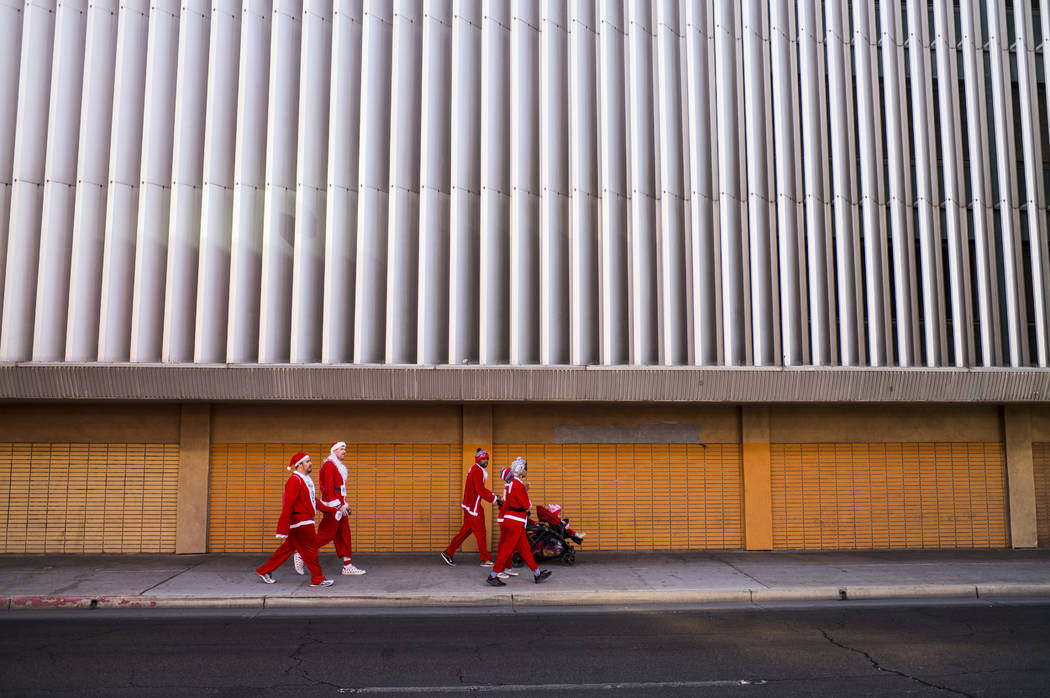 Race participants walk near the start area before the Las Vegas Great Santa Run in downtown Las Vegas on Saturday, Dec. 2, 2017. Chase Stevens Las Vegas Review-Journal @csstevensphoto