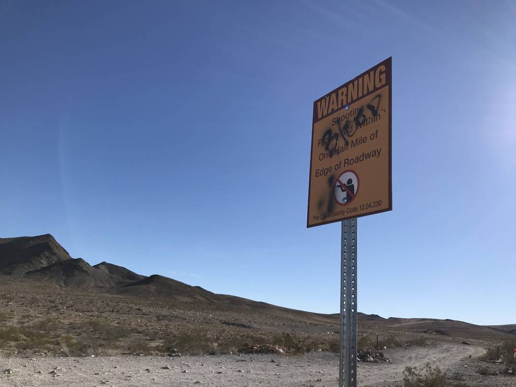 Graffiti obscures part of a sign outlining Clark County regulations at a popular target shooting area on public land just south of the Las Vegas Valley, Tuesday, Nov. 28, 2017. Henry Brean Las Veg ...