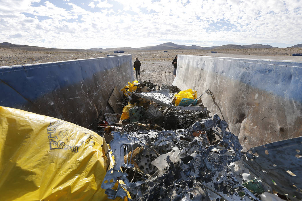 A dumpster begins to fill with trash collected during a volunteer cleanup hosted by the Bureau of Land Management at a popular target shooting area off South Las Vegas Boulevard, Saturday, Nov. 04 ...