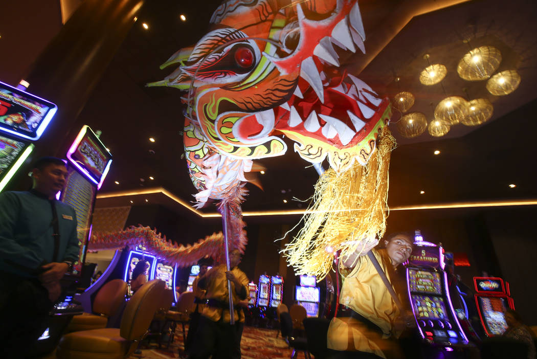 Oscar Cisneros, right, of the Lohan School of Shaolin entertains the crowd with a traditional lion and dragon dance during the 1-year anniversary of the Lucky Dragon in Las Vegas on Sunday, Dec. 3 ...