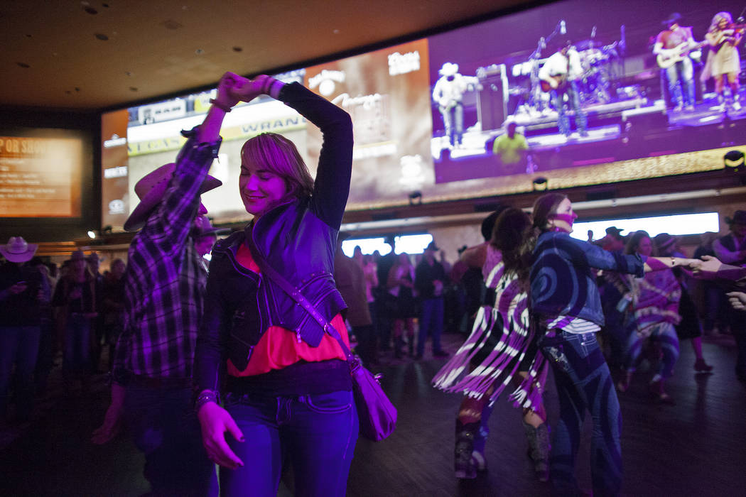 Melanie Arnold and Grant Huber dance to live music by Chancey Williams and the Younger Brothers Band at the Race & Sportsbook at the Mirage in Las Vegas. (Rachel Aston/Las Vegas Review-Journal ...