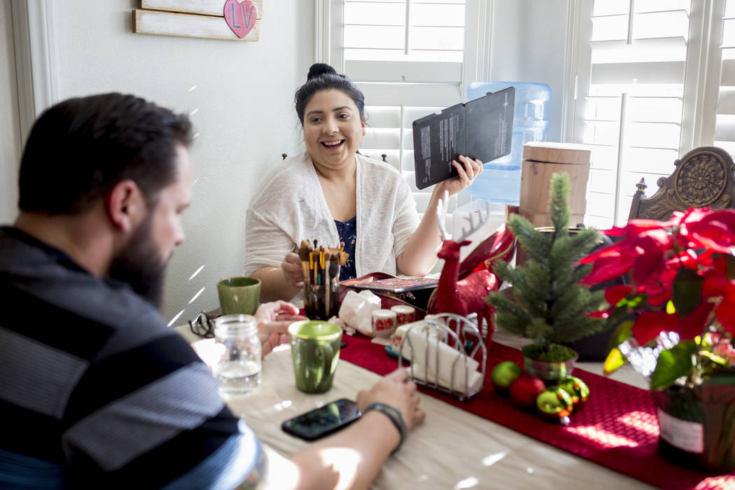 William King, left, and Kimberly Calderon talk while Calderon does her makeup in their home in Las Vegas, Wednesday, Dec. 13, 2017. Elizabeth Brumley Las Vegas Review-Journal  @EliPagePhoto