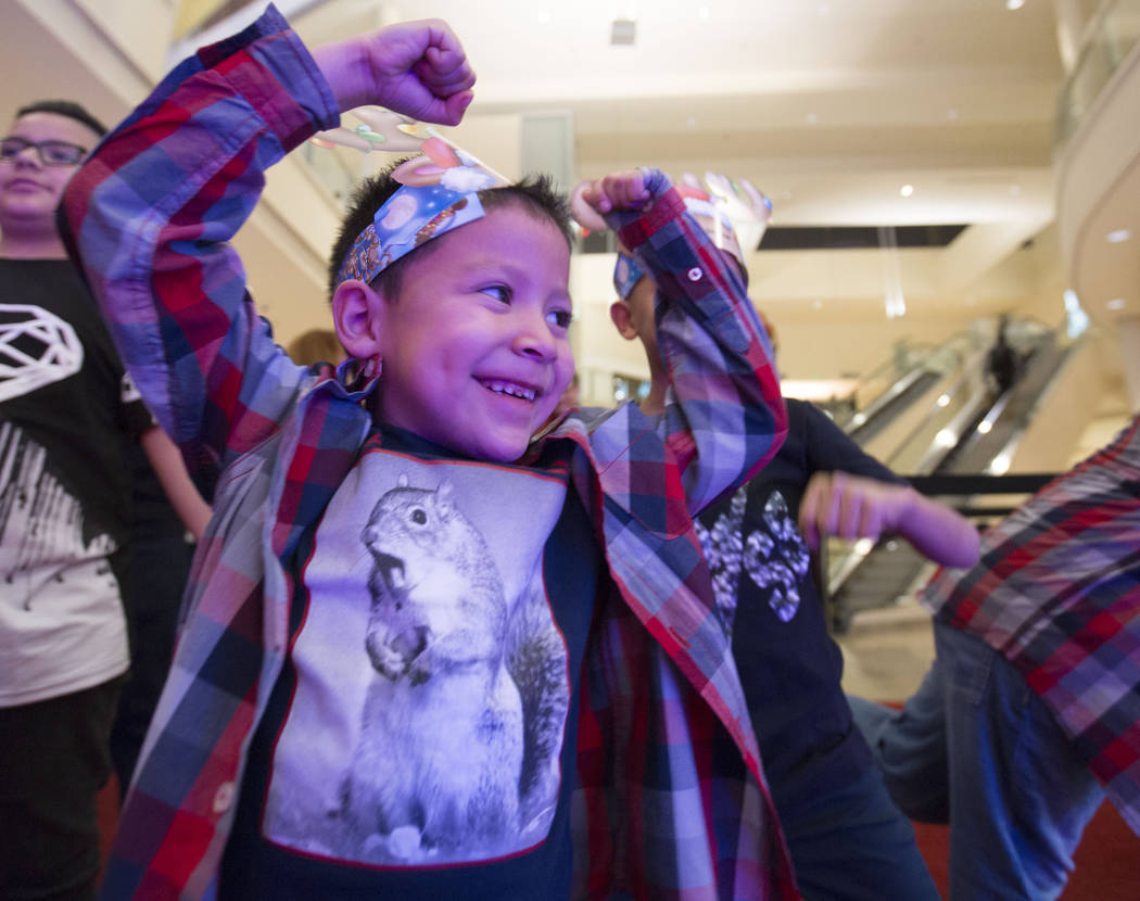 Maximus Calderon, 6, shows Santa how strong he is at Fashion Show Mall in Las Vegas, Wednesday, Dec. 6, 2017 in Las Vegas. Elizabeth Brumley Las Vegas Review-Journal  @EliPagePhoto