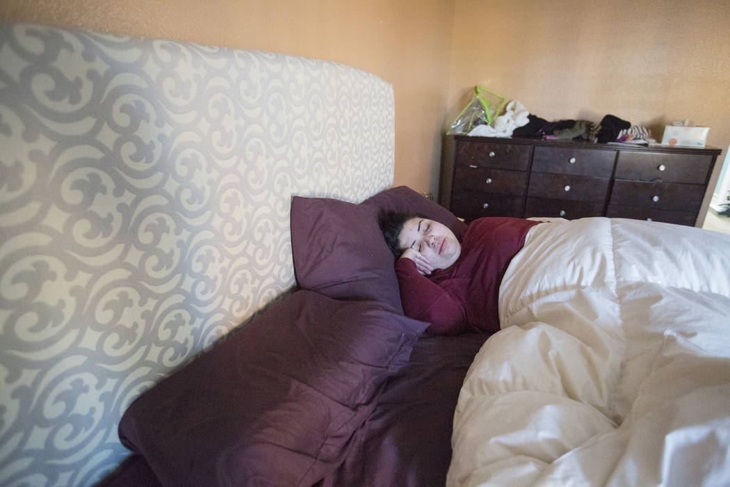 Kimberly Calderon, who struggles to sleep after the Oct. 1 shooting, lays in bed Thursday morning, Dec. 7, 2017 in Las Vegas. Elizabeth Brumley Las Vegas Review-Journal  @EliPagePhoto