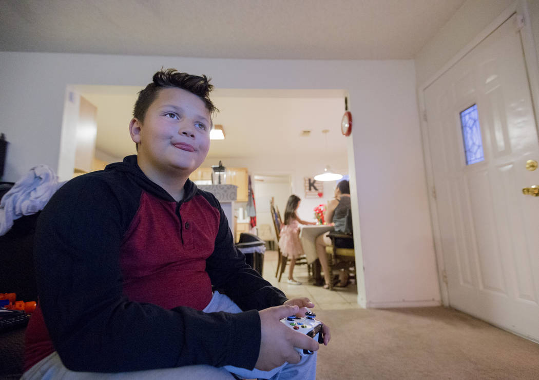 Eli King, 8, plays video games in his Las Vegas home Wednesday Dec. 6, 2017. Elizabeth Brumley Las Vegas Review-Journal  @EliPagePhoto
