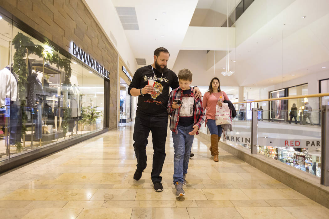William King, left, walks with his son Enoch King, 9, at the Fashion Show mall in Las Vegas Wednesday, Dec. 6, 2017. Elizabeth Brumley Las Vegas Review-Journal  @EliPagePhoto