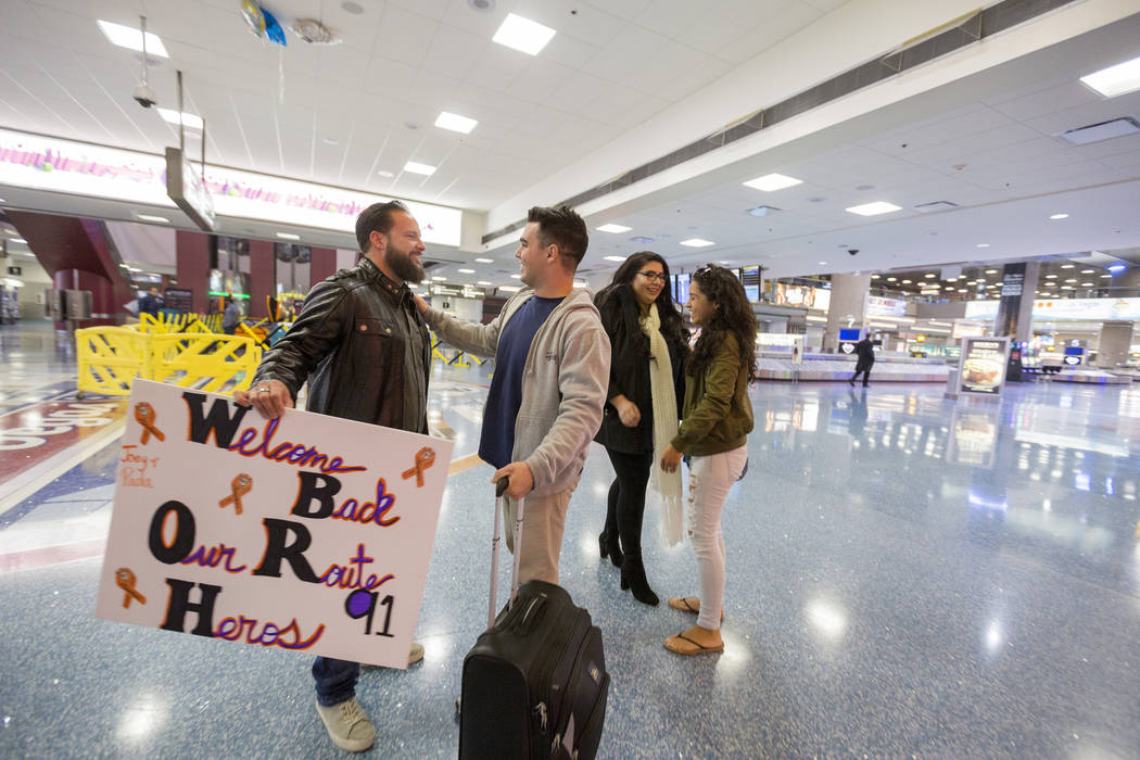 William King, from left, Joseph Nolan, Kimberly Calderon and Paol Nolan meet Saturday, Dec. 9, 2017, at McCarran International Airport in Las Vegas. It was the first time the couples has met since ...