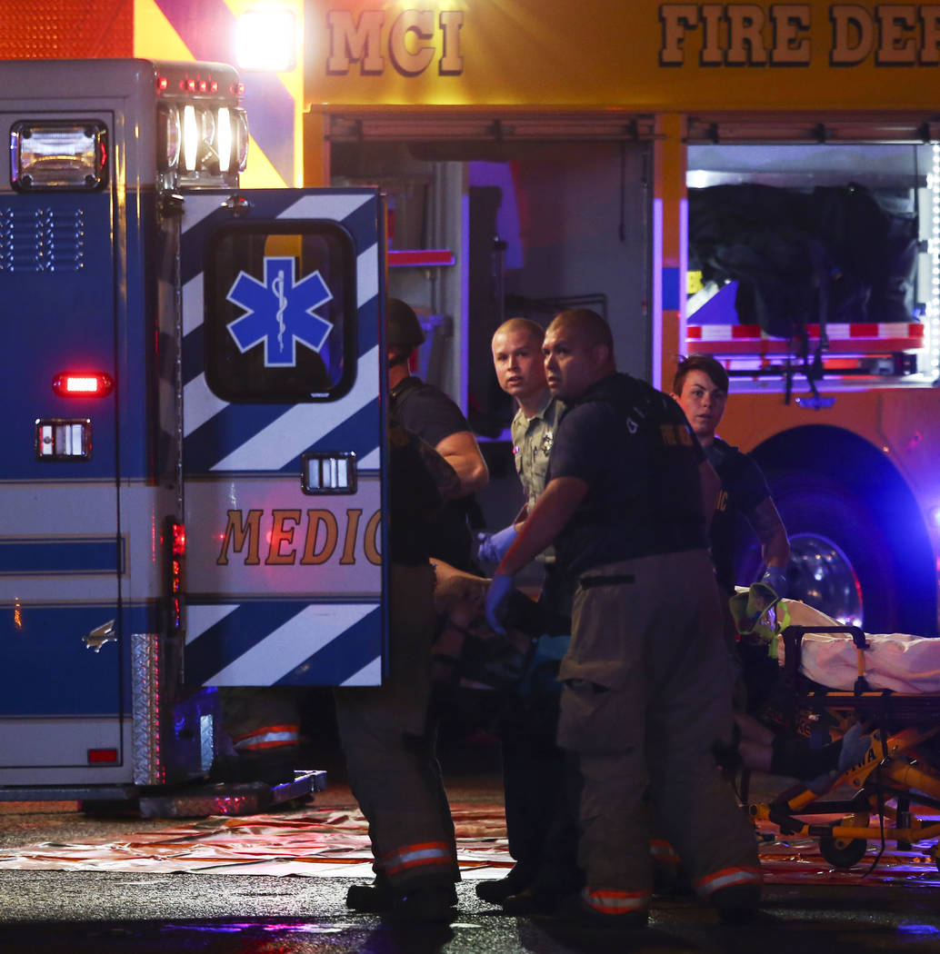 A body is loaded into an ambulance by emergency workers as Las Vegas police respond during an active shooter situation on the Las Vegas Strip on Sunday, Oct. 1, 2017. Chase Stevens Las Vegas Revie ...