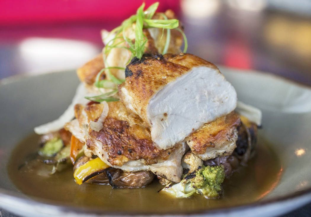 Brick pressed roasted chicken with roasted vegetables, potatoes al pastor, pickled fennel, guajillo and chicken thyme jus at Bandito Latin Kitchen & Cantina on Saturday, Dec. 2, 2017, in Las V ...