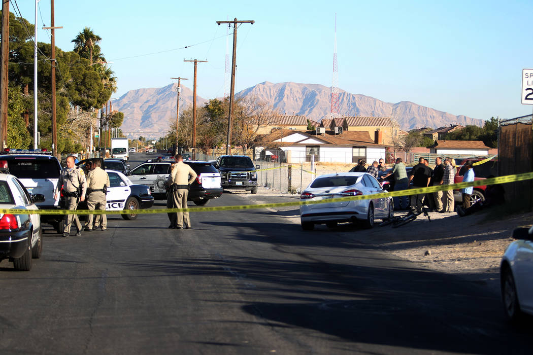 Las Vegas police investigate the scene at the corner of Holly Avenue and Allen Lane near Rancho and Vegas drives Friday, Dec. 1, 2017, where a male shooting victim was found in the street. K.M. Ca ...