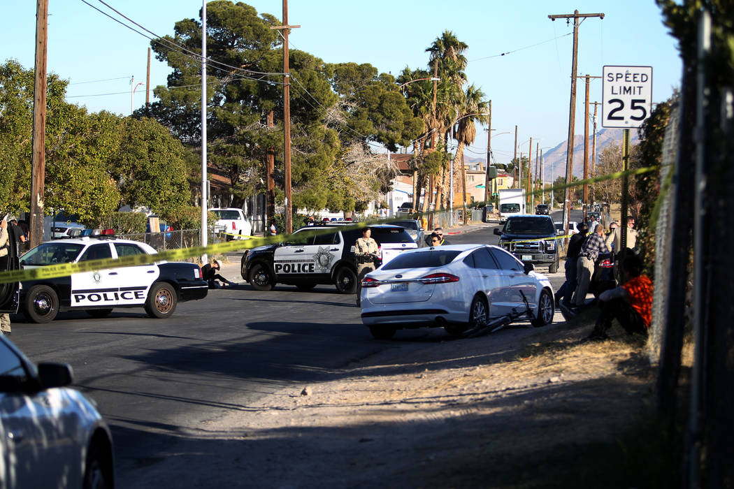 Las Vegas police investigate the scene at the corner of Holly Avenue and Allen Lane near Rancho and Vegas drives Friday, Dec. 1, 2017, where a male shooting victim was found in the street. K.M. Ca ...