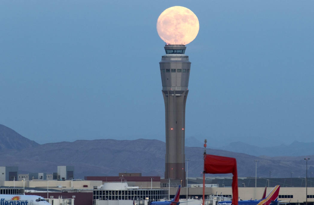 December's nearly full moon rises over an air traffic control tower at McCarran International Airport in Las Vegas Saturday, Dec. 2, 2017. Richard Brian Las Vegas Review-Journal @vegasphotograph
