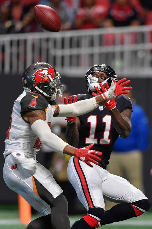 Nov 26, 2017; Atlanta, GA, USA; Atlanta Falcons wide receiver Julio Jones (11) catches a touchdown pass behind Tampa Bay Buccaneers safety Justin Evans (21) during the first half at Mercedes-Benz ...
