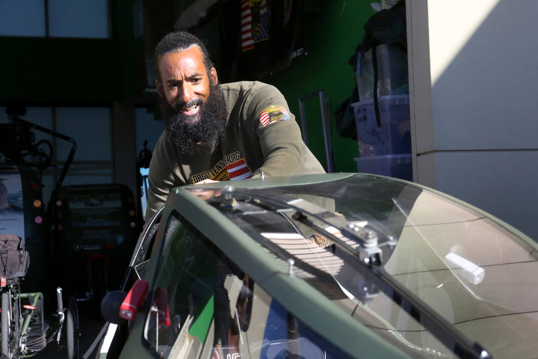 Peter Guidry, co-founder of Forgotten Not Gone, an organization whose goal is the prevention of veteran suicide, pushes a recumbent bike out of the nonprofit’s Las Vegas living/office space on W ...