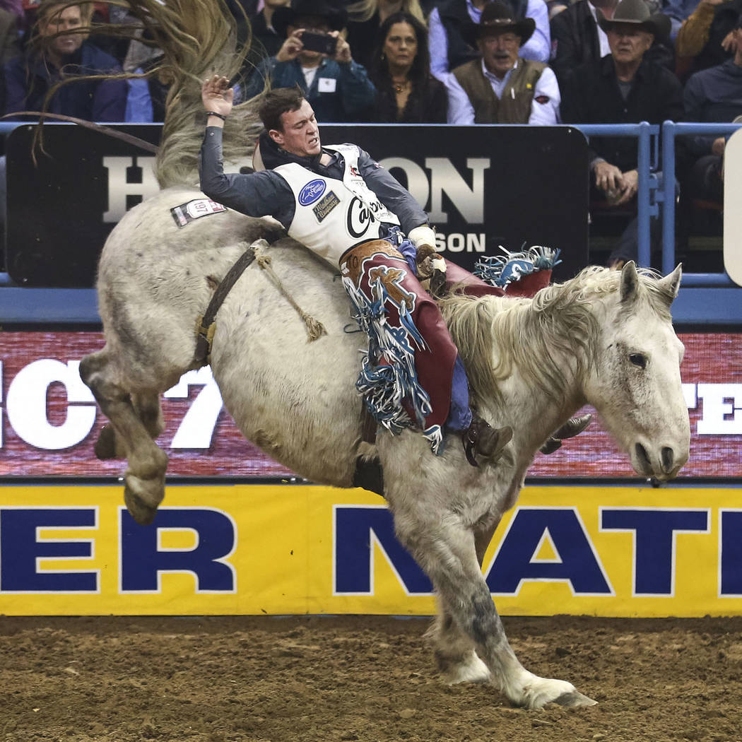 Tim O'Connell of Zwingle, Iowa rides Mucho Dinero in the bareback riding competition in the tenth go-round of the National Finals Rodeo, Saturday, Dec. 16, 2017, at the Thomas & Mack Center in ...