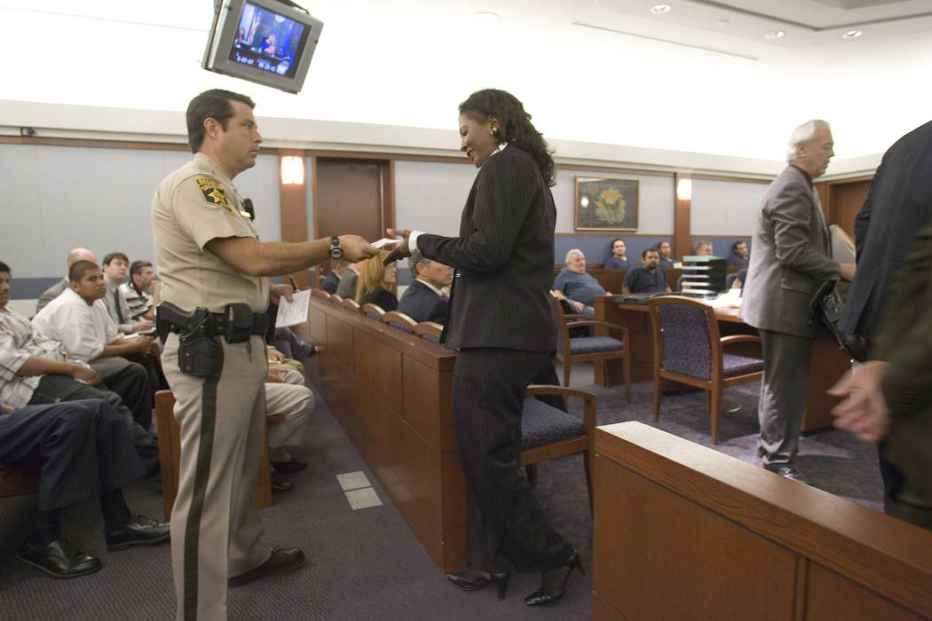Former county commissioner Lynette Boggs is handed information by a Las Vegas Justice Court ballif, Thursday morning,  June 7, 2007, after appearing before Las Vegas Justice Court Judge Osterle to ...