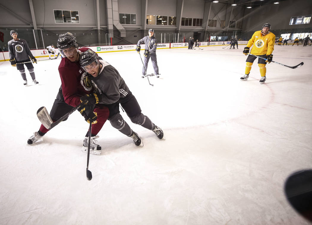 Vegas Golden Knights left wing David Perron (57) and defenseman Brad Hunt (77) vie for the puck during the NHL team's practice at the City National Arena in Las Vegas, Wednesday, Dec. 6, 2017. Ric ...