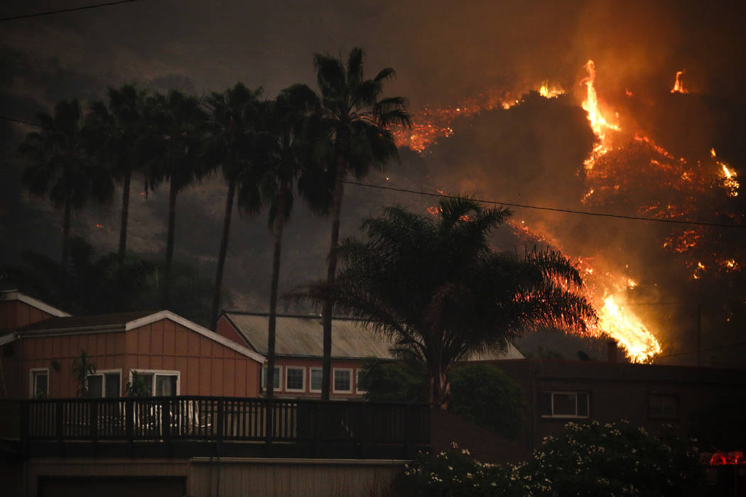 A wildfire threatens homes as it burns along a hillside in La Conchita, Calif., Thursday, Dec. 7, 2017. The wind-swept blazes have forced tens of thousands of evacuations and destroyed dozens of h ...