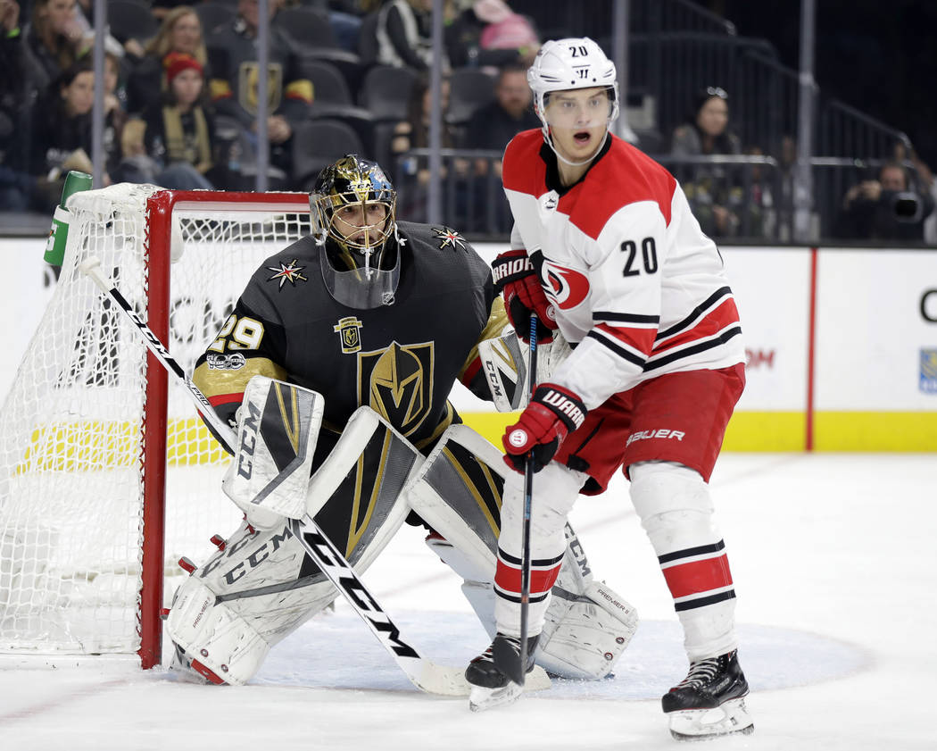 Carolina Hurricanes right wing Sebastian Aho (20) and Vegas Golden Knights goalie Marc-Andre Fleury watch play during the second period of an NHL hockey game Tuesday, Dec. 12, 2017, in Las Vegas. ...